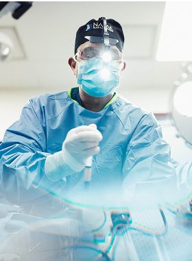 Surgeon preparing for medical procedure in surgical attire.