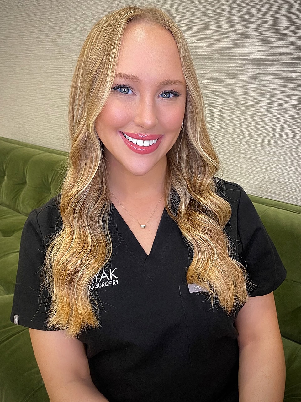 Smiling female medical professional in black attire.