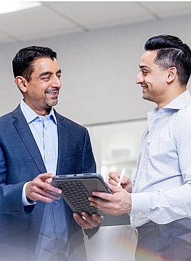 St. Louis facial plastic surgeon Dr. Nayak and Dr. Kachare speaking together.