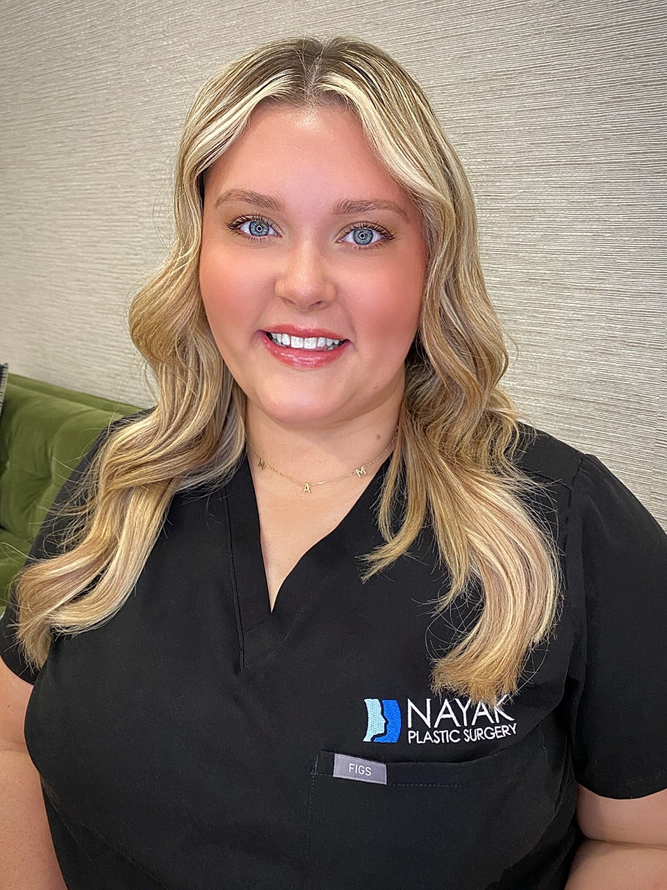 Healthcare professional smiling in scrubs.