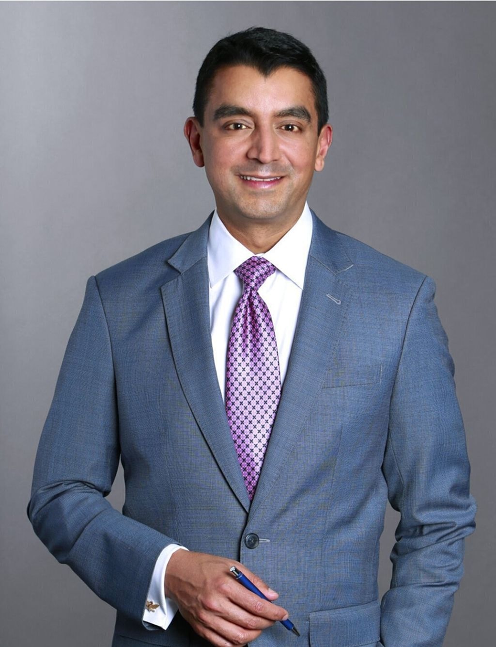 Professional man in business suit, smiling confidently.