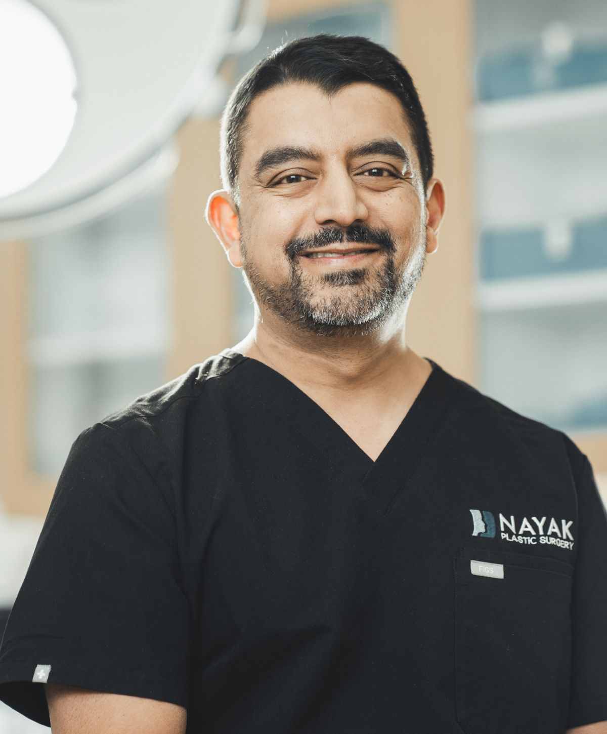 St. Louis facial plastic surgery, Dr. Nayak in surgical scrubs.