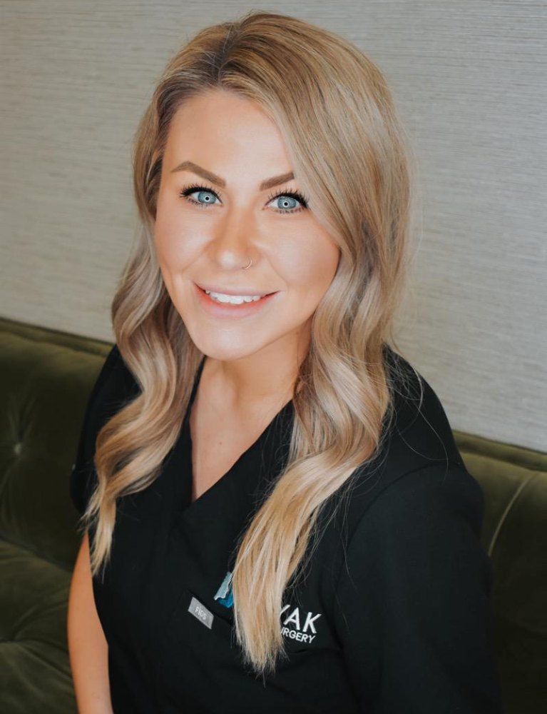 Smiling woman in medical professional attire.