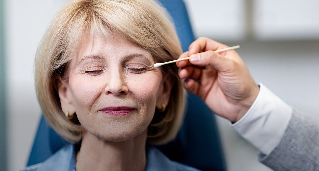 St. Louis facial plastic surgery model receiving beauty treatment with closed eyes.