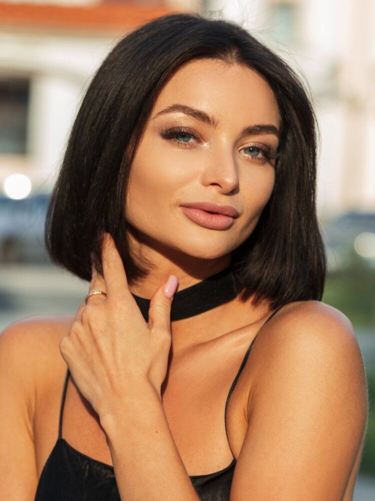 Woman with short hair and elegant makeup.