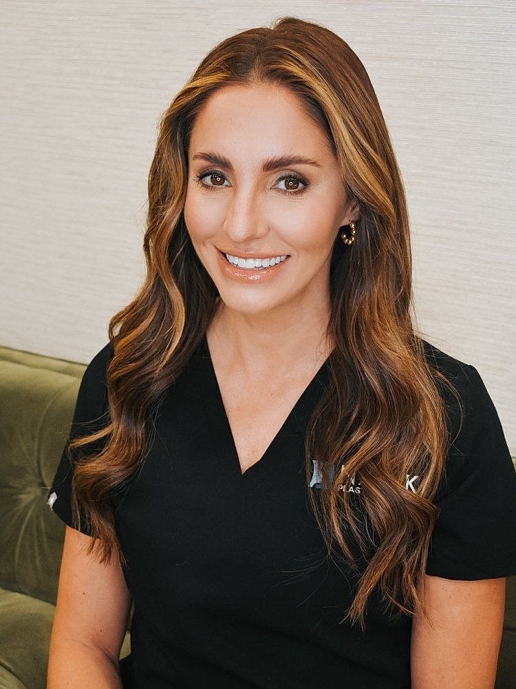 Smiling professional in medical attire.