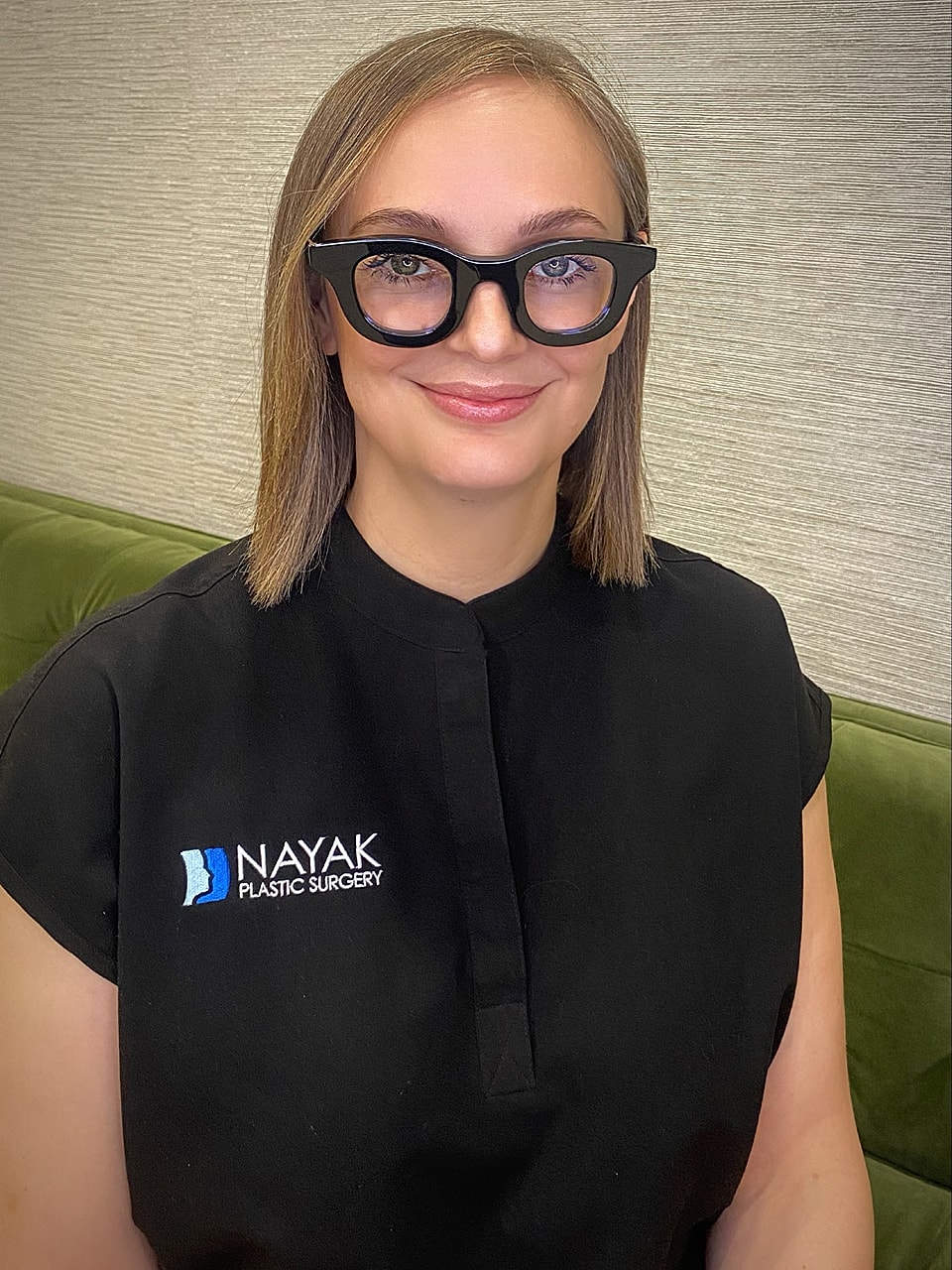 Professional woman in plastic surgery clinic attire.