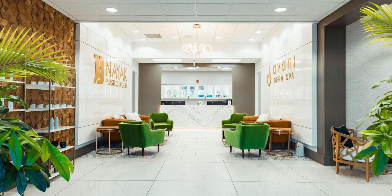 Modern medical office interior with green seating.