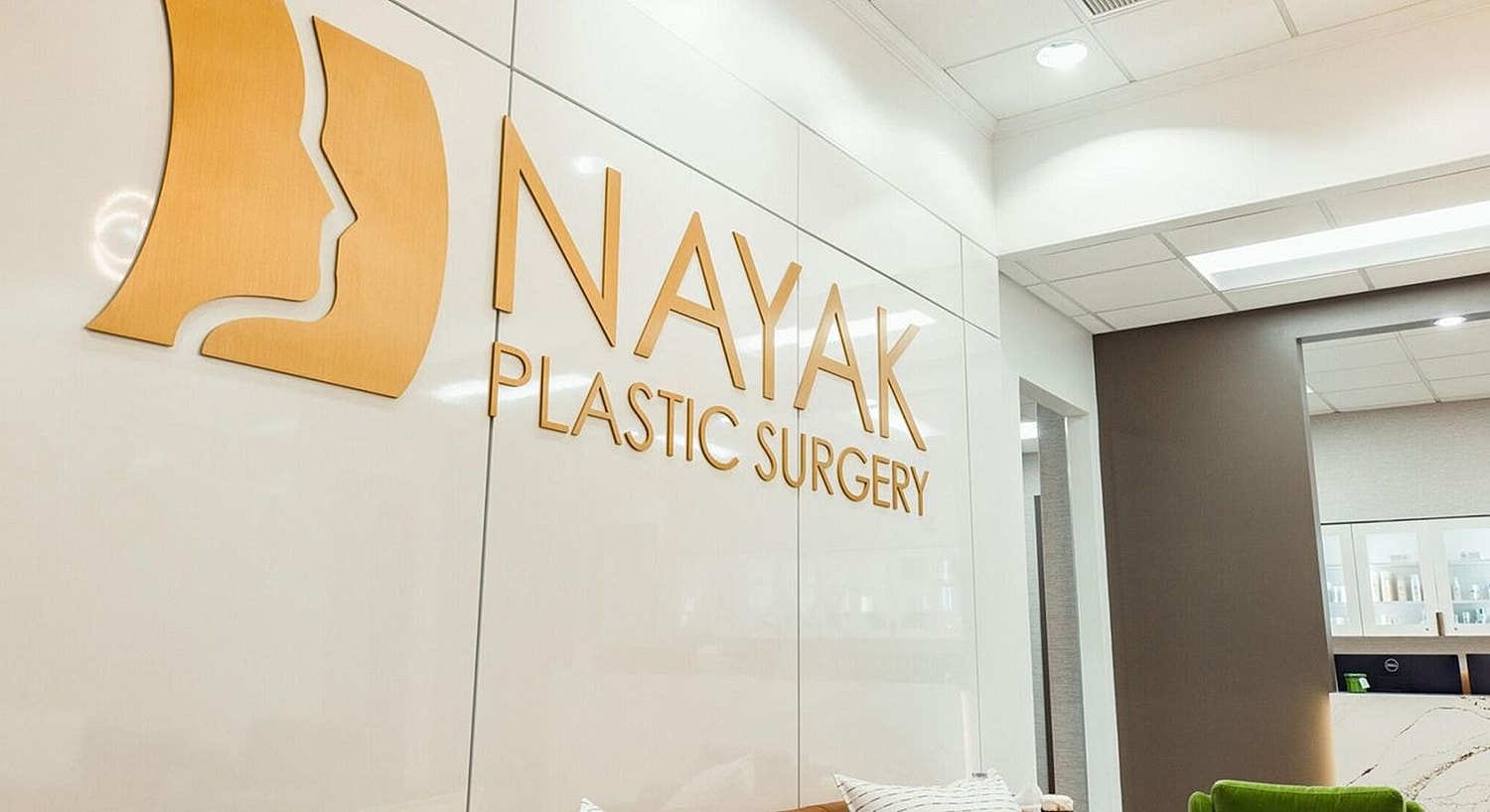 Nayak Plastic Surgery office interior with logo