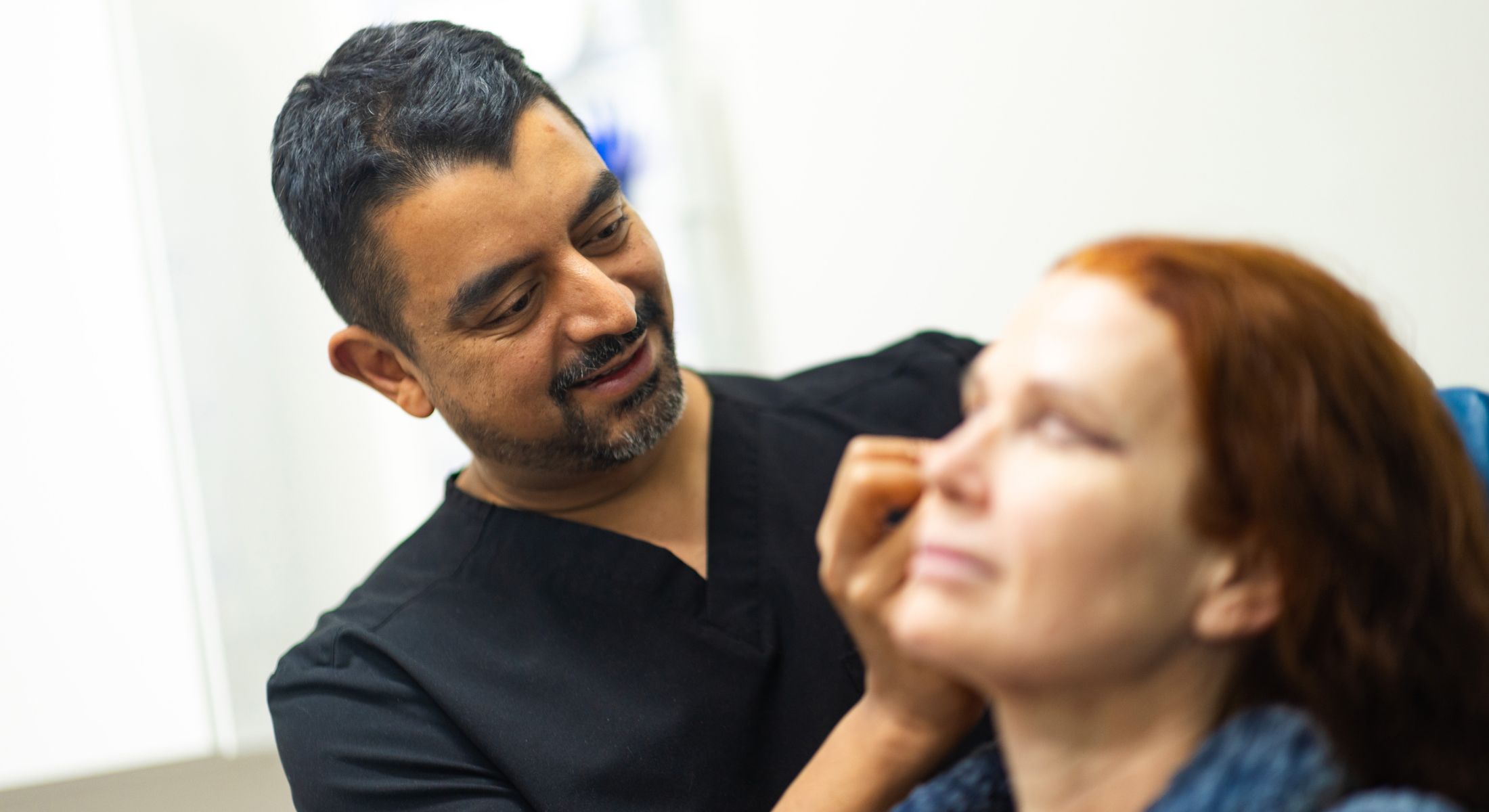 Smiling doctor in a surgical environment.