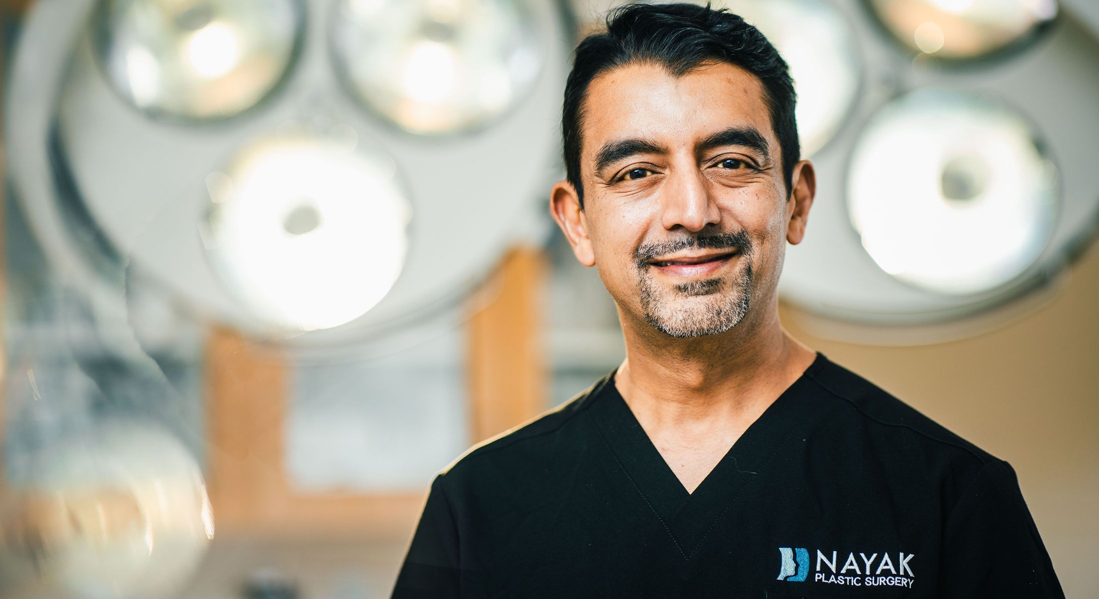 Nayak Plastic Surgery reception area and logo