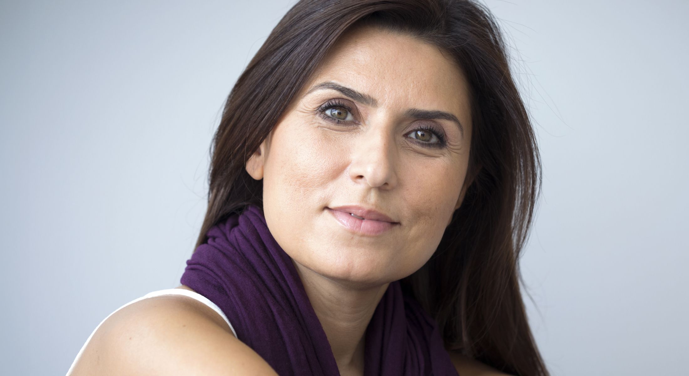 Portrait of a woman with long dark hair.