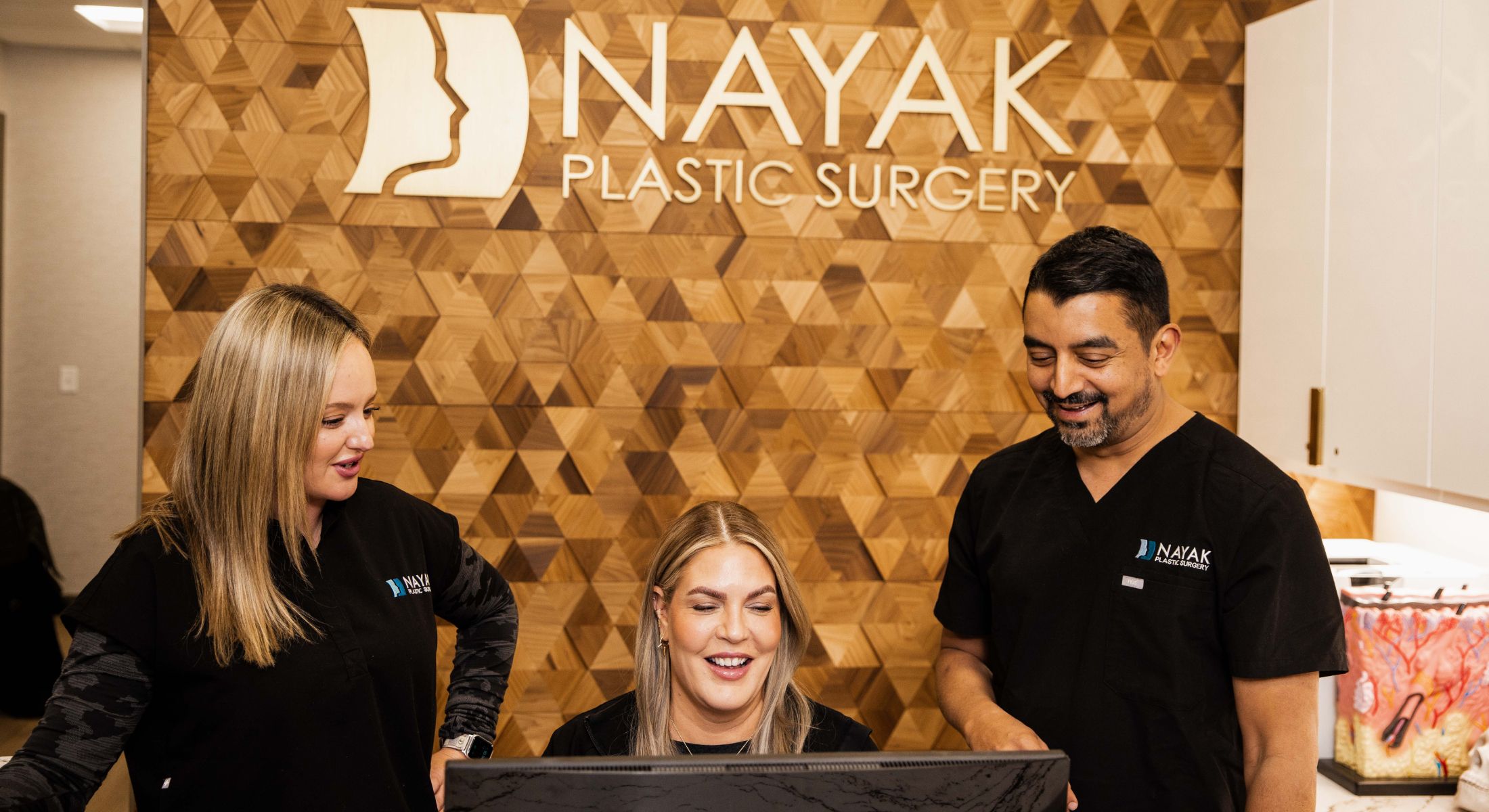 Staff collaborating at Nayak Plastic Surgery office.
