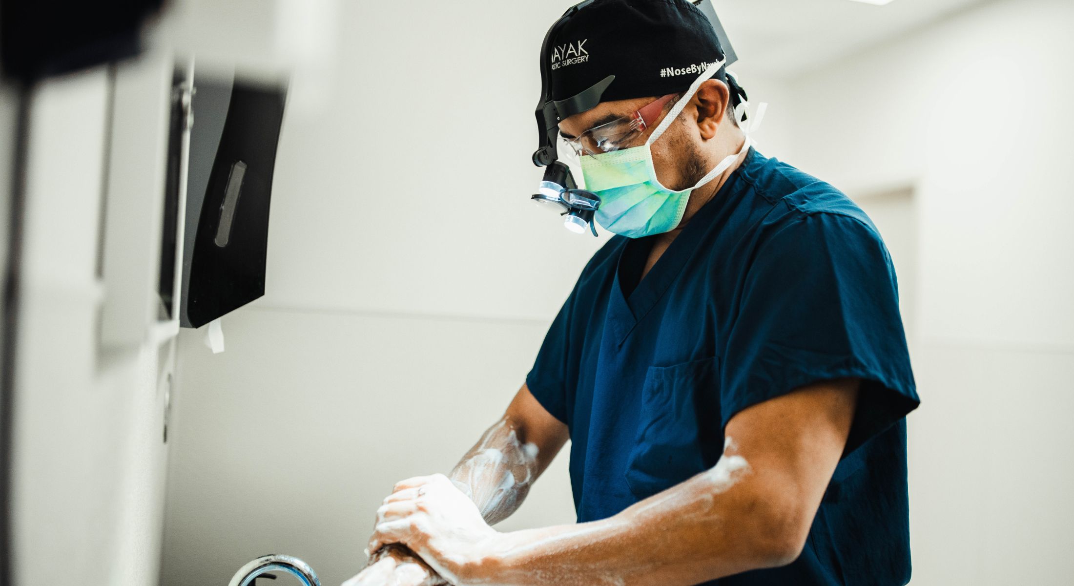 Surgeon preparing for a procedure in scrubs.