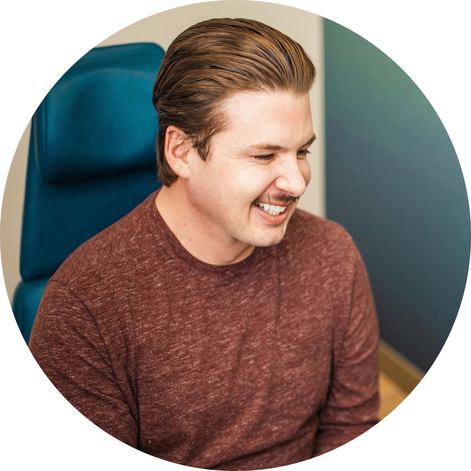 Smiling man sitting in a comfortable chair.