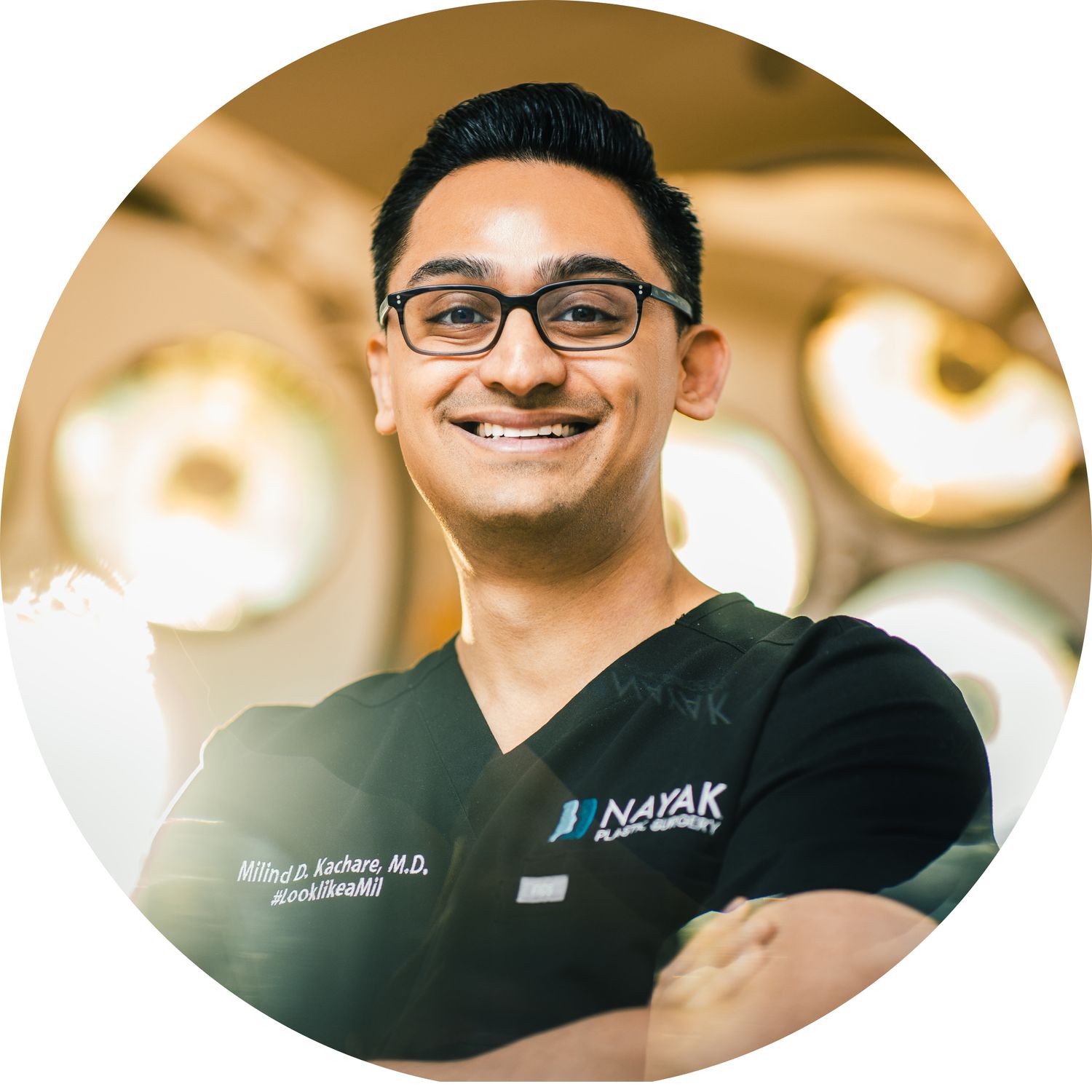 Surgeon smiling in an operating room setting.